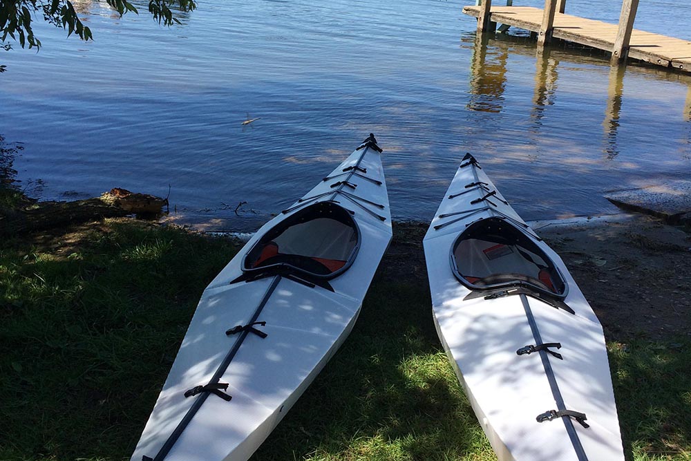 Two Oru Kayaks on the edge of the lake.